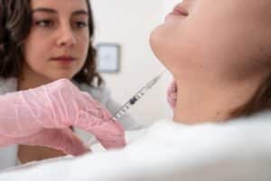 Woman getting Kybella injections in her chin in Dallas, TX