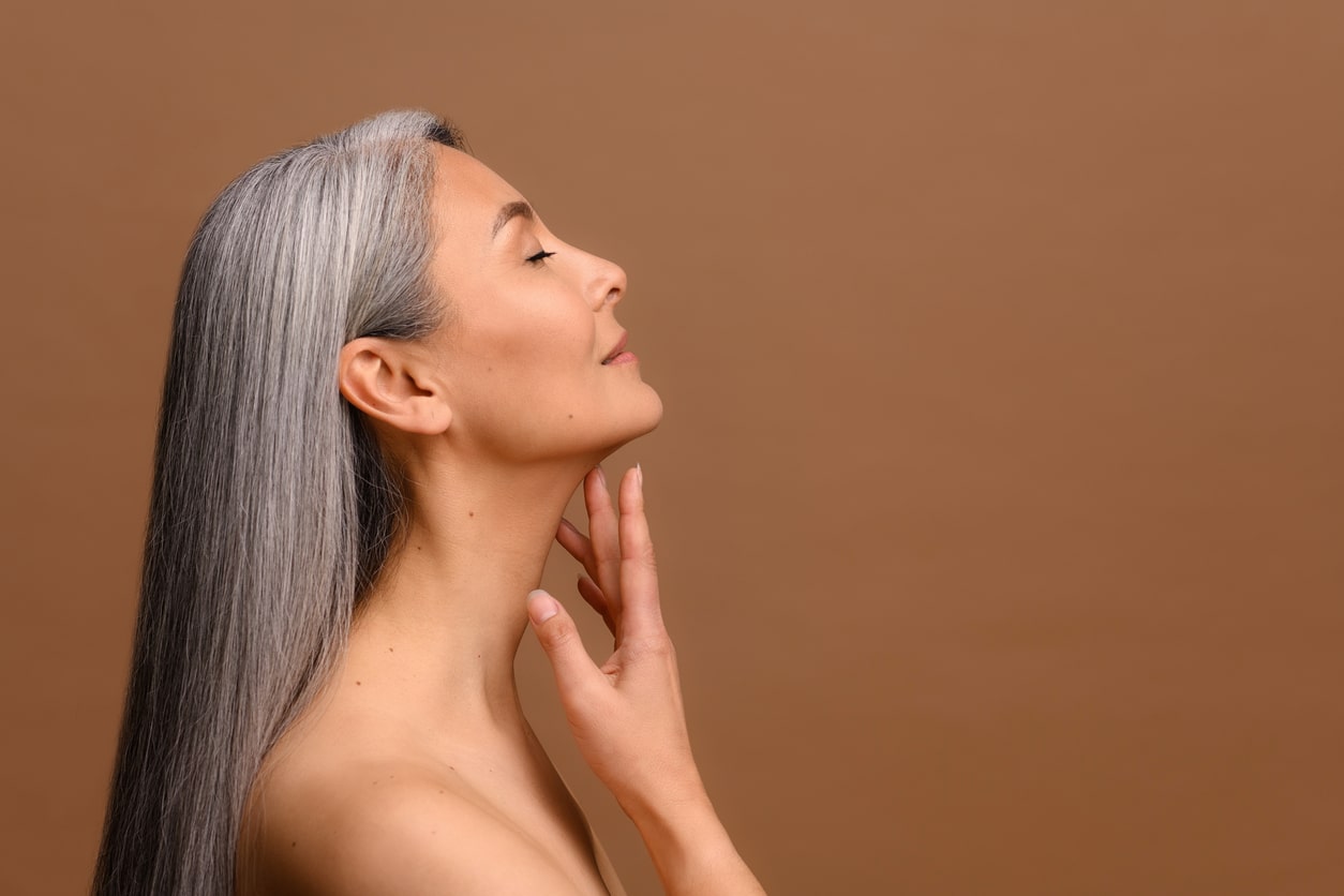 A profile shot of a woman after neck liposuction in Dallas