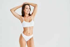 Woman posing in white underwear after plastic surgery following GLP-1 weight loss